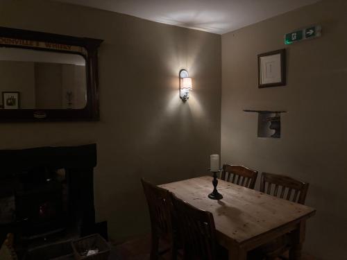 a room with a table with a light on the wall at The Royal Oak in Eydon