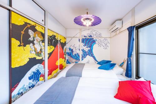 a bedroom with a white bed and a mural at LEON RESORT HOTEL A 3rooms MAX8people 6min Shinjuku 11min Shibuya 12min walk Ikebukuro LEON RESORT IKEBUKURO traditional Japanese room 池袋 最大8名 in Tokyo
