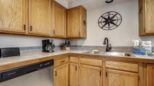 a kitchen with wooden cabinets and a sink at Skyline Condo 02 in Sunriver