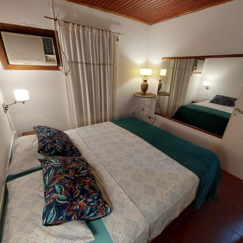 a small bedroom with a bed and a mirror at La esquina in Dos de Mayo