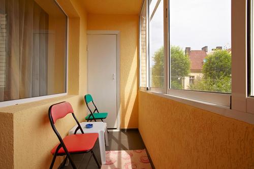 two chairs sitting in a room with a window at Apartment Oksi in Lviv