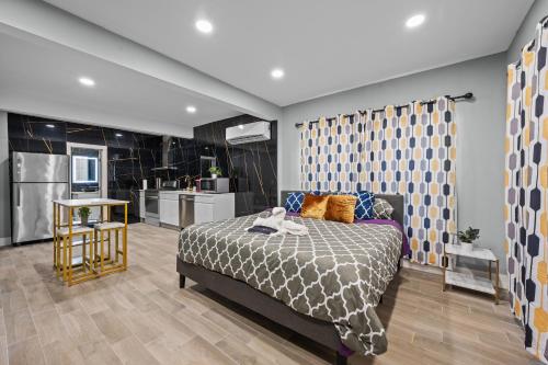 a bedroom with a bed and a kitchen at Charming Midtown Studio with Free Parking in Houston