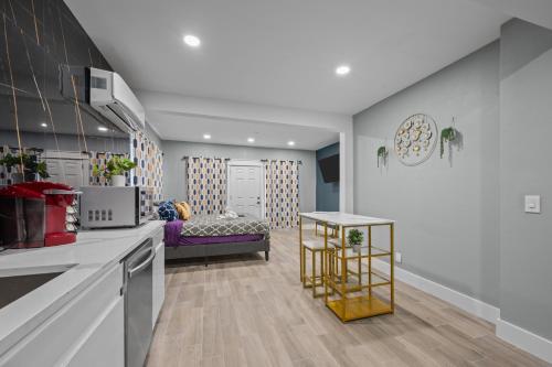 a kitchen and living room with a couch in the background at Charming Midtown Studio with Free Parking in Houston