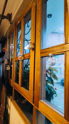 a wooden cabinet with windows in a room at LAGUNA HOUSE in Huaraz