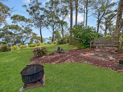 a park with a bench and a trash can at Spacious 4-Bed Home with Coastal Charm in Long Beach