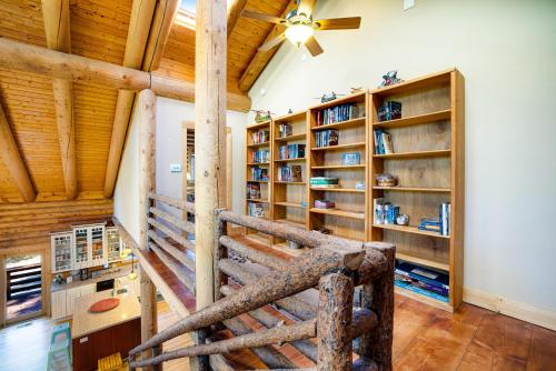 a staircase in a room with wooden ceilings and bookshelves at The Cub Inn in Groveland