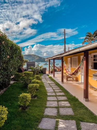 a walkway next to a house with a view of the ocean at Pousada Porto Girassol in Abraão