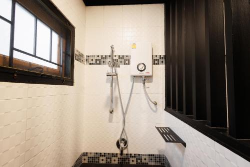 a shower stall in a bathroom with a window at T House in Bang Tao Beach