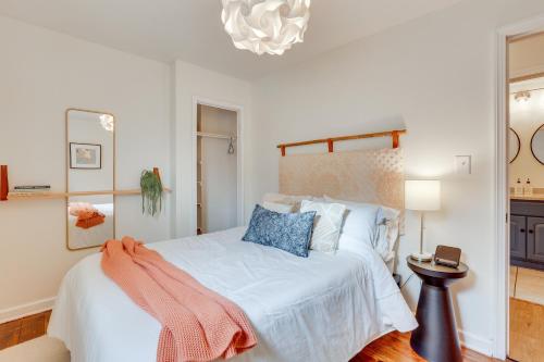 a bedroom with a bed with white sheets and blue pillows at Patio and Lake Views Family-Friendly Canton Retreat in Canton