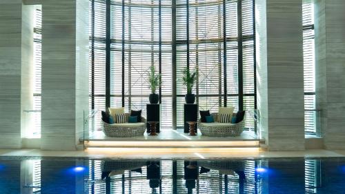 a room with a large window with chairs and a table at Fairmont Riyadh in Riyadh