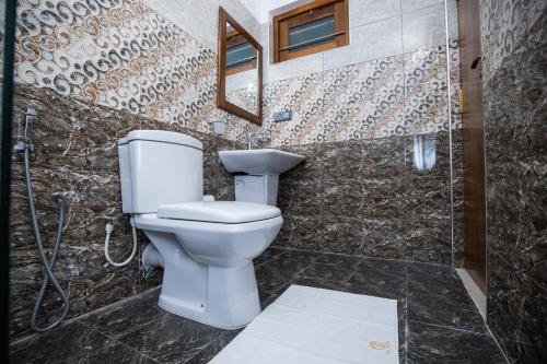 a bathroom with a toilet and a shower at Villa Freedom in Hikkaduwa