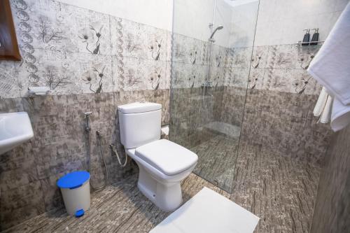 a bathroom with a toilet and a shower at Villa Freedom in Hikkaduwa