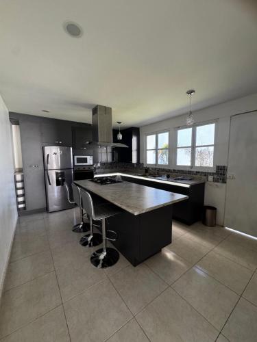 a large kitchen with a large island in the middle at Rubeta in Yelateni