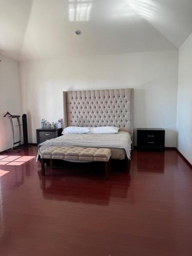 a bedroom with a large bed with a large headboard at Rubeta in Yelateni
