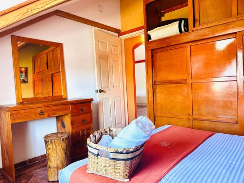 a bedroom with a bed with a basket on a table at Hotel & Suites Cerro Roj0 in Tlatlauquitepec