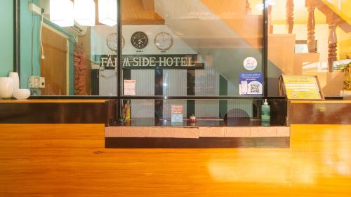 a store window with a counter with clocks on the wall at RedDoorz @ Farm Side Hotel Laoag City in Laoag