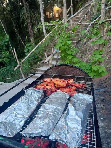 a grill with some meat on top of it at Baruk Mas Kampung Assum in Kuching