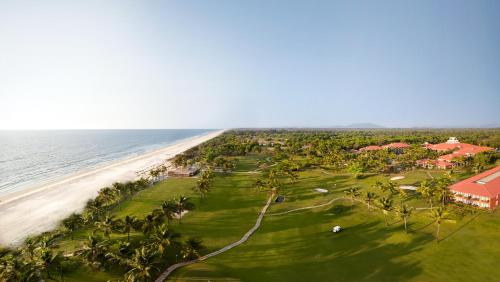 an aerial view of a golf course and the ocean at Caravela Beach Resort in Varca