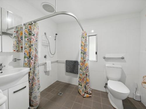 a bathroom with a toilet and a sink and a shower at Westlee Cottage in Wentworth Falls