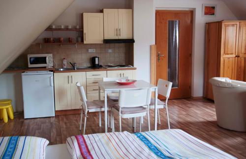 a kitchen with a table and chairs in a room at Apartments Odměny U Třeboně in Třeboň