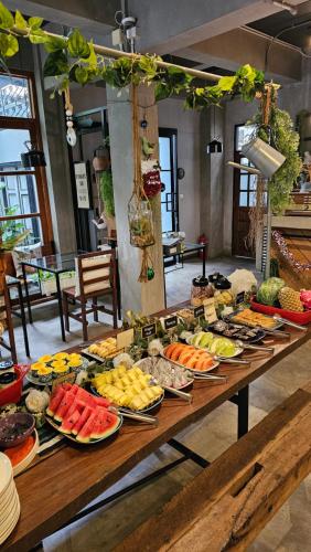 a table filled with lots of different types of food at Hansa Bangkok House in Bangkok