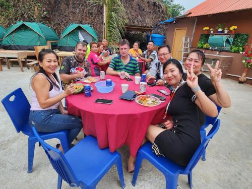 a group of people sitting around a table eating at Baruk Mas Kampung Assum in Kuching
