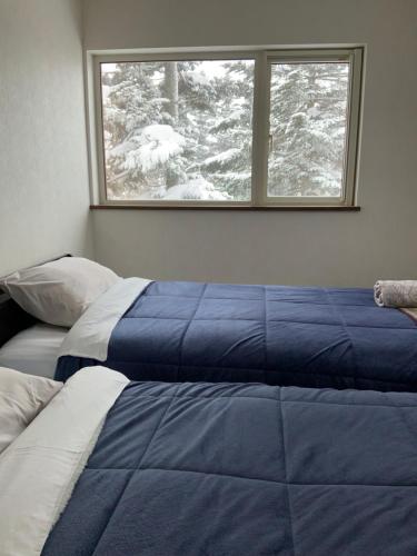 Ένα ή περισσότερα κρεβάτια σε δωμάτιο στο Soga Niseko home