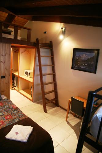 a room with a bed and a ladder on the wall at Alpine Retreat Mt Buller in Mount Buller