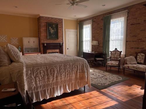 a bedroom with a bed and a living room at Tanglewood Inn in Greenville