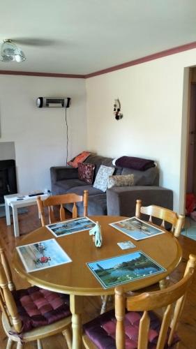 a table and chairs in a living room with a couch at Cheerful Bush House in Hepburn Springs