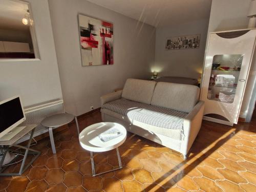 un salon avec un canapé et une table dans l'établissement Studio avec coin-nuit, terrasse et parking privé près du centre de Sainte-Maxime, Golfe de Saint-Tropez - FR-1-780-60, à Sainte-Maxime