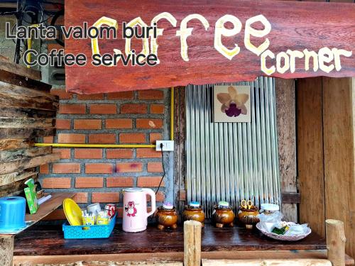 a sign for a coffee shop with a group of pots at Lanta Valom buri in Ko Lanta