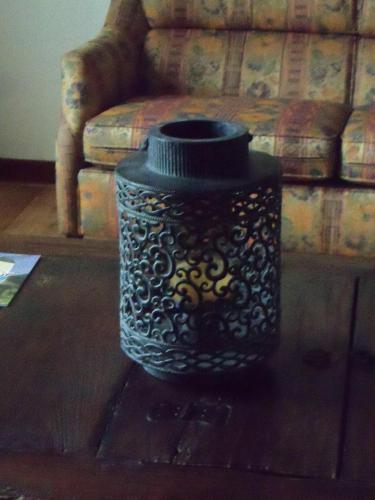 a black vase sitting on a table in front of a couch at Hoeve Heidonk in Horn