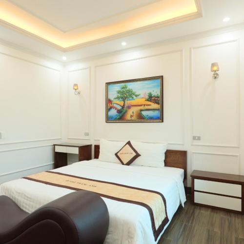a bedroom with two beds and a painting on the wall at Trang Anh Hotel Bắc Giang in Bắc Giang