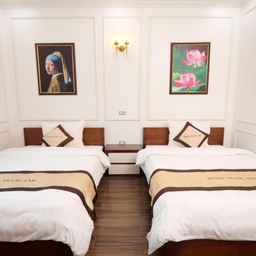 a row of three beds in a room at Trang Anh Hotel Bắc Giang in Bắc Giang