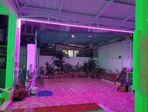 a large room with a pink floor and purple lights at Ban Suanlum in Bangkok