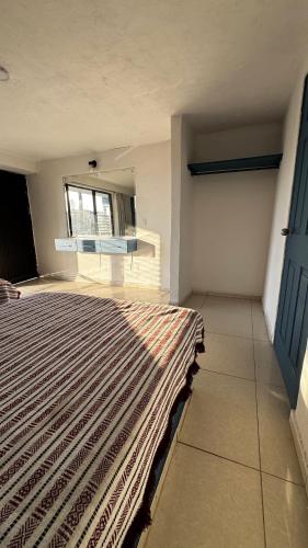 a bedroom with a rug on the floor and a window at Hotel Nuevo Vallarta in Guadalajara