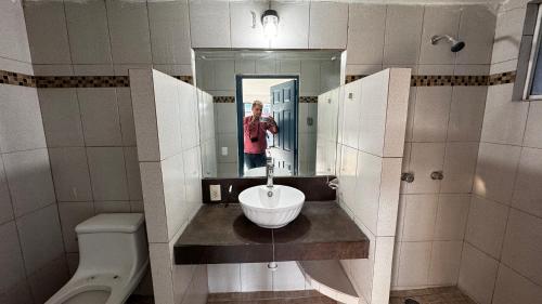 a man taking a picture in a bathroom mirror at Hotel Nuevo Vallarta in Guadalajara