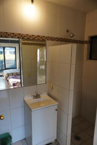 a bathroom with a sink and a mirror at Hotel Nuevo Vallarta in Guadalajara