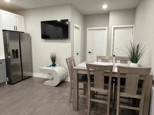 a kitchen with a table and chairs and a refrigerator at Charming 3BR 2BA with Private Patio in Philadelphia