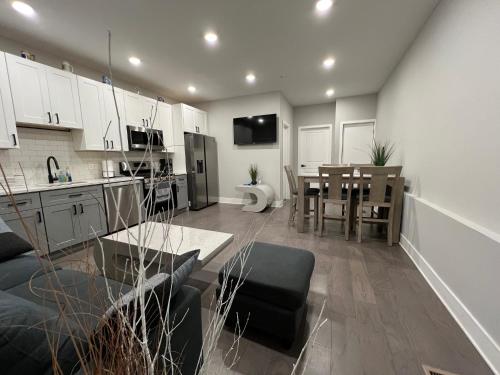 a living room with a kitchen and a dining room at Charming 3BR 2BA with Private Patio in Philadelphia
