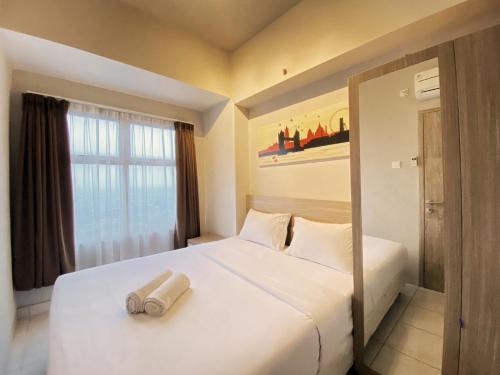 Postel nebo postele na pokoji v ubytování Relaxing 1BR at Apartment at Newton Residence Bandung By Travelio