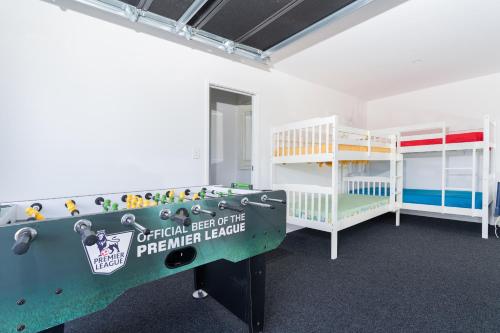 a room with a bed and bunk beds in it at Karioi Mountain View in Raglan