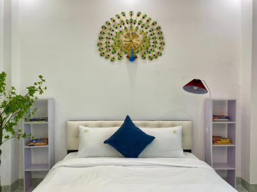 a bedroom with a bed and a clock on the wall at The Grand Diamond C Tuong Mai in Hanoi