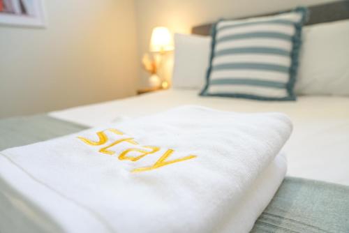 a white bed with the word bed written on it at StayAU 5BRM Coastal Retreat for Families Baldivis in Baldivis