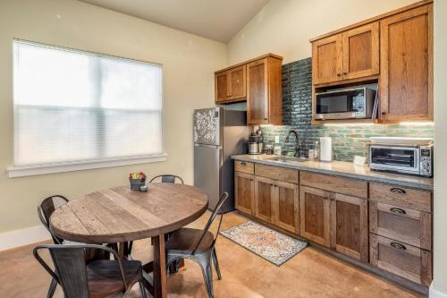 a kitchen with a wooden table and a table and a tableablish at Driftwood Casitas - Birdsong Casita in Wimberley