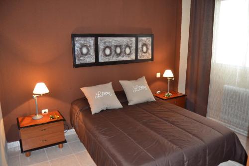 a bedroom with a bed with two night stands and two lamps at Apartamento Santa Eulalia in Merida