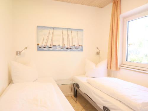 Postel nebo postele na pokoji v ubytování Die Erdgeschosswohnung befindet sich in Alt-Westerland.