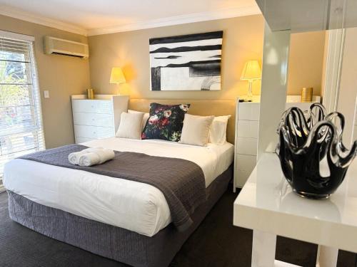 a bedroom with a large bed and a table at 22 Home Sweet Home Coastal Currambine in Perth