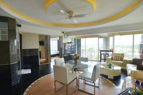 a living room with a couch and a table at Penthouse Galare Thong Tower - Stunning Views - Near Pool & Tennis in Chiang Mai